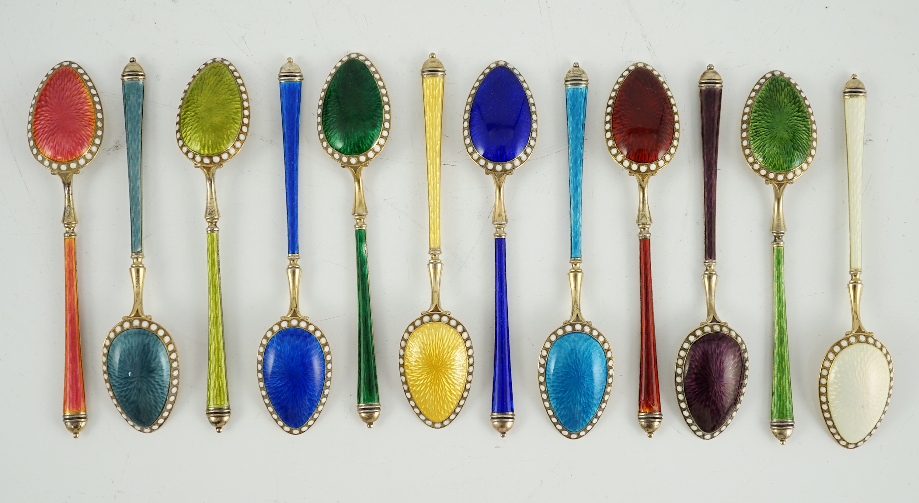 A cased set of twelve Norwegian silver gilt and polychrome enamel coffee spoons, retailed by Tiffany & Co